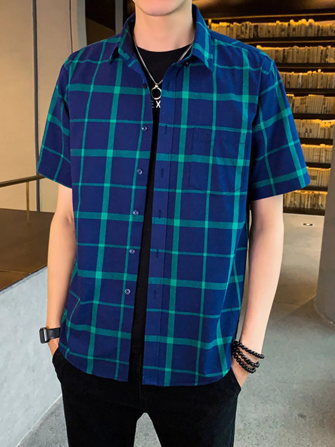 NEWYORKLISTED ATLAS MEN'S COLLECTION: Person wearing a blue and green plaid shirt indoors.