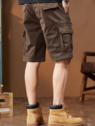 NEWYORKLISTED ATLAS MEN's COLLECTION: Brown cargo shorts worn by a person with a blurred background