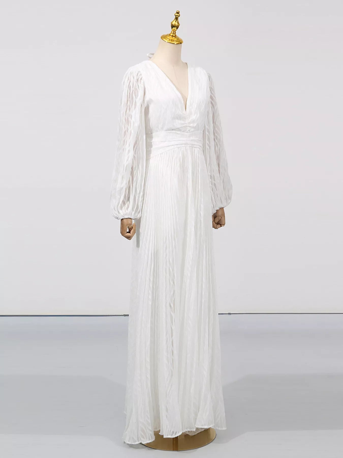 NEWYORKLISTED STYLE COLLECTION: White dress on a mannequin against a plain background