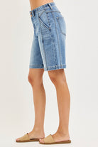 NEWYORKLISTED STYLE COLLECTION: Denim shorts worn by a person on a plain background