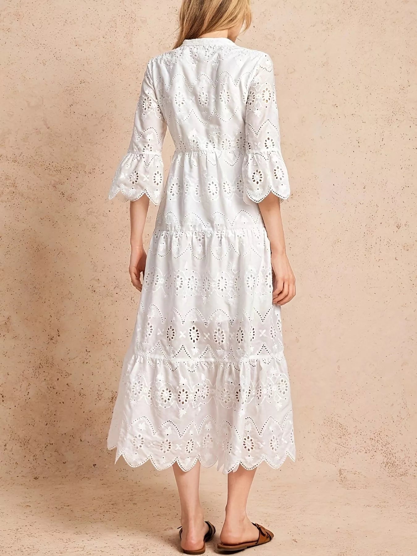 NEWYORKLISTED STYLE COLLECTION: White lace dress on a beige background