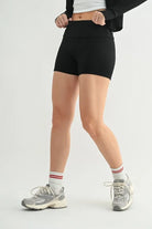 NEWYORKLISTED ACTIVEWEAR: Person wearing black high-waisted shorts on a white background 