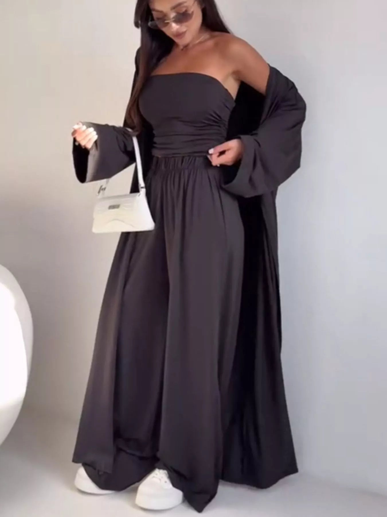 NEWYORKLISTED COMFORT COLLECTION: Woman wearing a long black dress with a white background