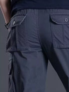 NEWYORKLISTED ATLAS MEN's COLLECTION: Navy blue cargo pants with multiple pockets on a dark background