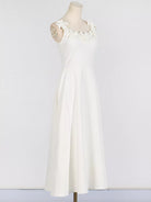 NEWYORKLISTED STYLE COLLECTION: White dress on a mannequin against a plain background