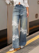 NEWYORKLISTED STYLE COLLECTION: Person wearing blue jeans with white lace details on a train platform.