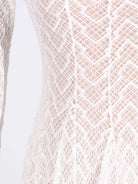 NEWYORKLISTED STYLE COLLECTION: Close-up of a textured beige fabric with a diamond pattern on a white background
