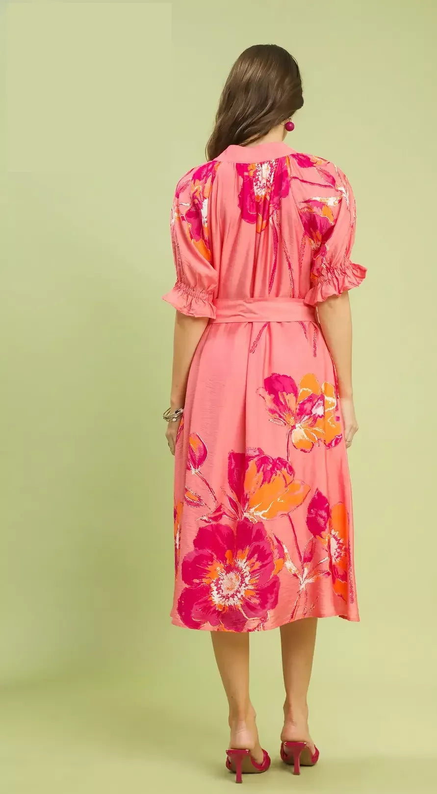 NEWYORKLISTED STYLE COLLECTION: Woman wearing a pink floral dress against a light green background