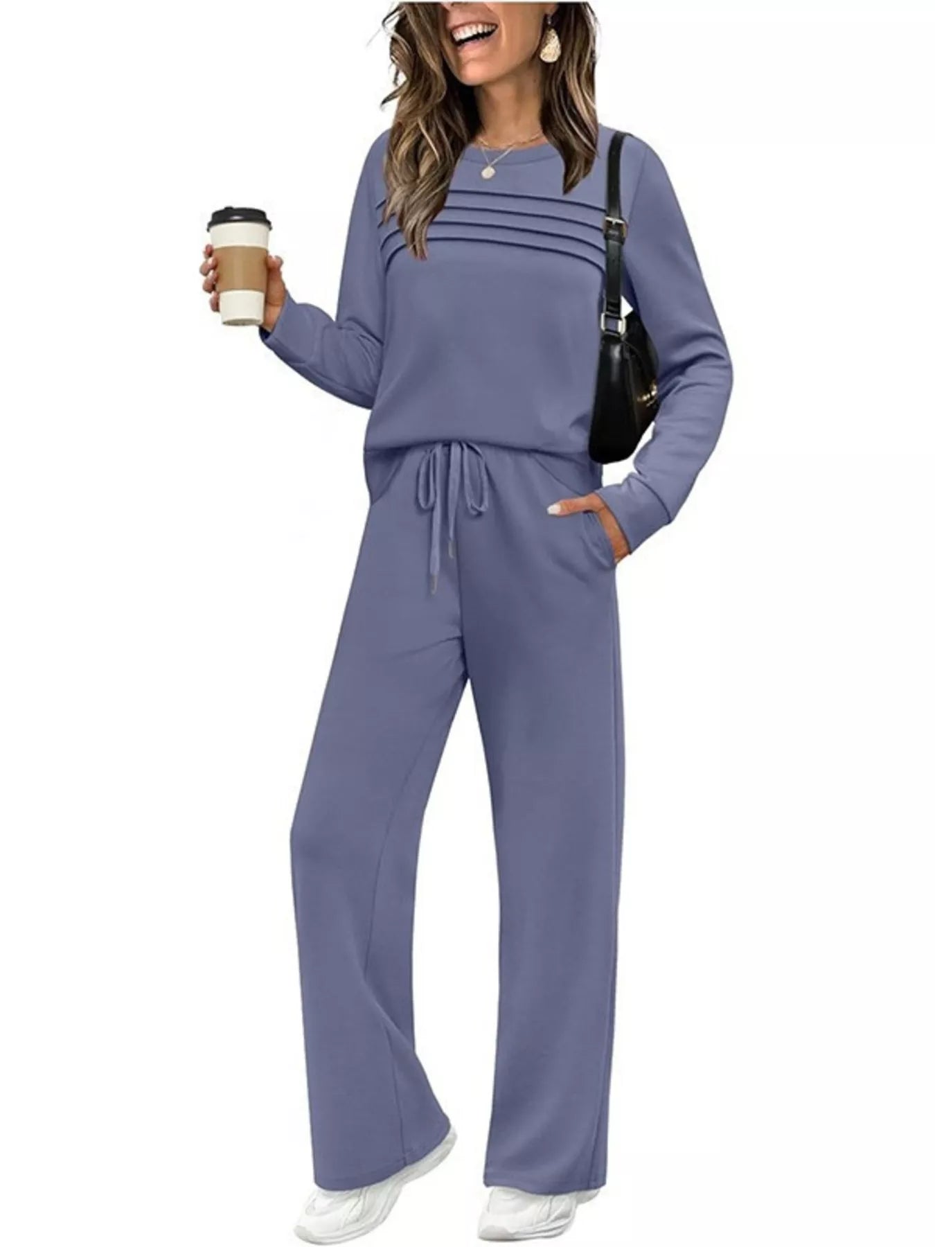 NEWYORKLISTED COMFORT COLLECTION: Woman wearing a purple lounge set holding a coffee cup on a white background