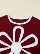 NEWYORKLISTED STYLE COLLECTION: Red garment with a white floral design on a beige background