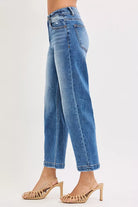 NEWYORKLISTED DENIM COLLECTION: Blue jeans worn by a person on a white background
