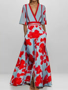 NEWYORKLISTED STYLE COLLECTION: Woman wearing a red and blue floral dress on a white background