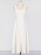 NEWYORKLISTED STYLE COLLECTION: White dress on a mannequin against a plain background