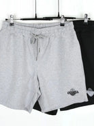 NEWYORKLISTED ATLAS MEN's COLLECTION: Gray shorts with a brand logo on a hanger against a white background