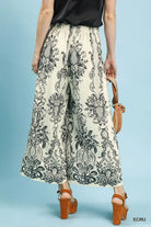 NEWYORKLISTED STYLE COLLECTION: Person wearing patterned pants with a plain background