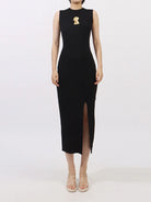 NEWYORKLISTED RUNWAY STYLE: Black sleeveless dress with a slit on a white background