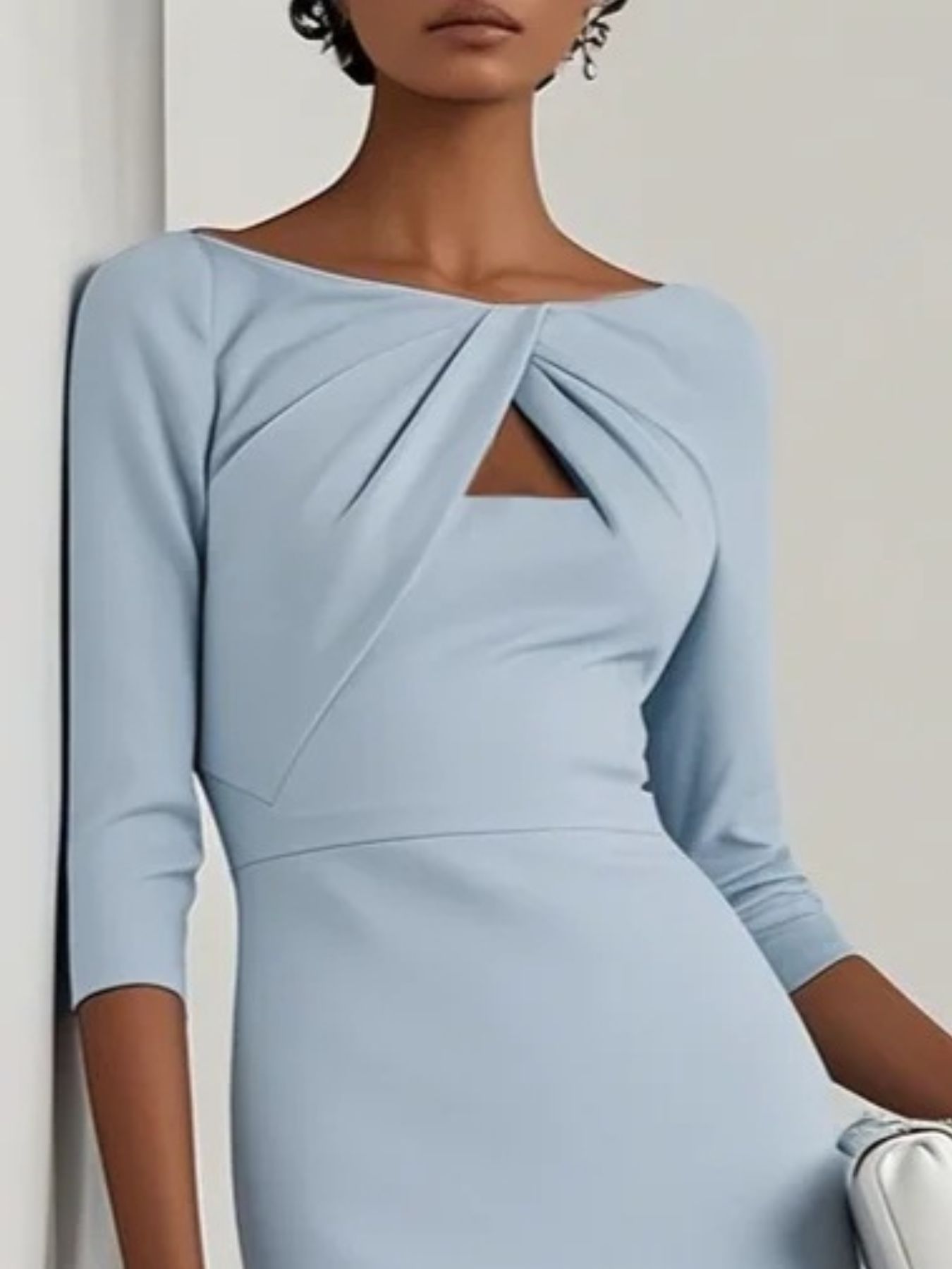 NEWYORKLISTED STYLE COLLECTION: Light blue dress with a knot detail on a plain background
