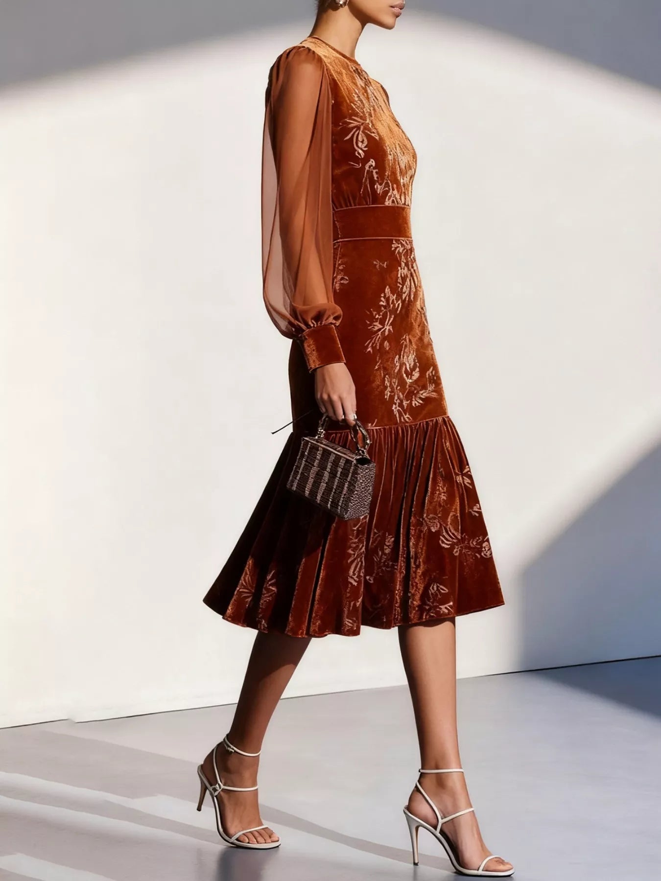 NEWYORKLISTED RUNWAY STYLE: Woman wearing a brown floral dress with sheer sleeves against a white background