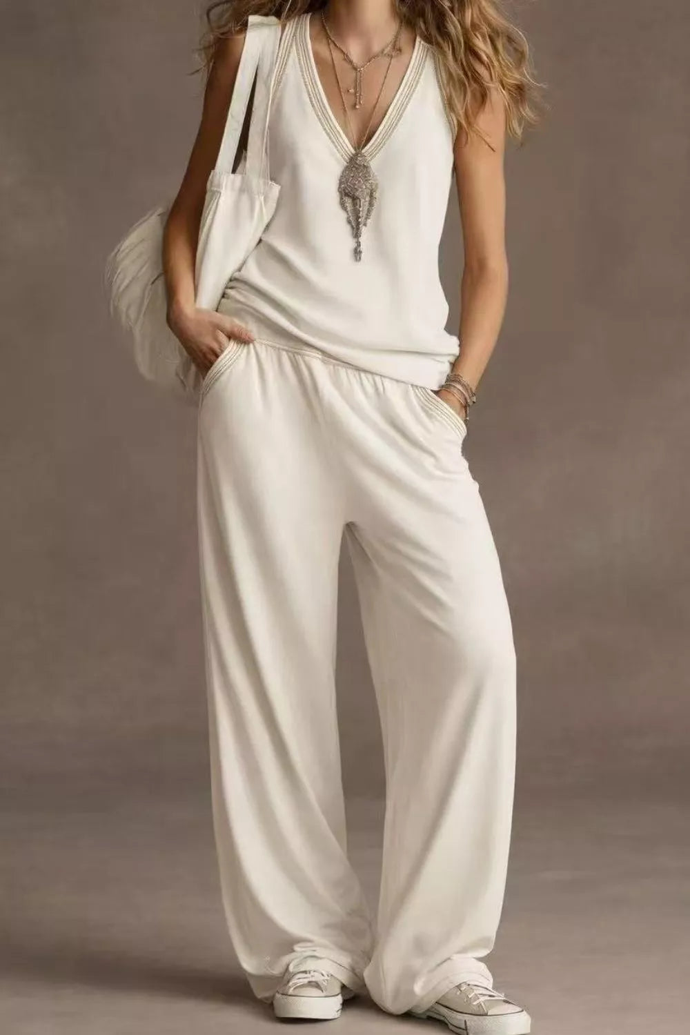 NEWYORKLISTED STYLE COLLECTION: Woman wearing a white outfit with a plain background