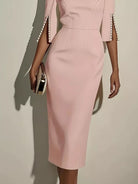 NEWYORKLISTED STYLE COLLECTION: Pink dress with pearl details on sleeves against a neutral background