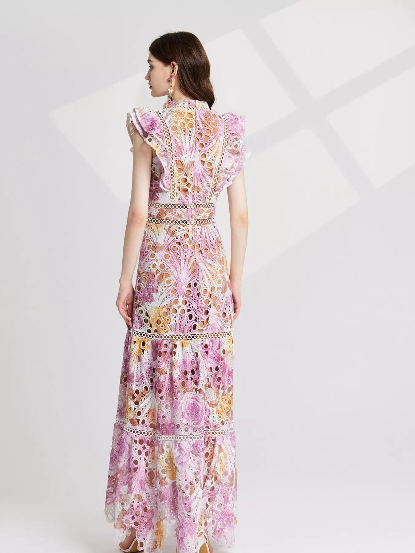 NEWYORKLISTED STYLE COLLECTION: Woman wearing a floral dress on a white background