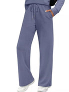 NEWYORKLISTED COMFORT COLLECTION: Purple scrubs with drawstring top and wide-leg pants on a white background