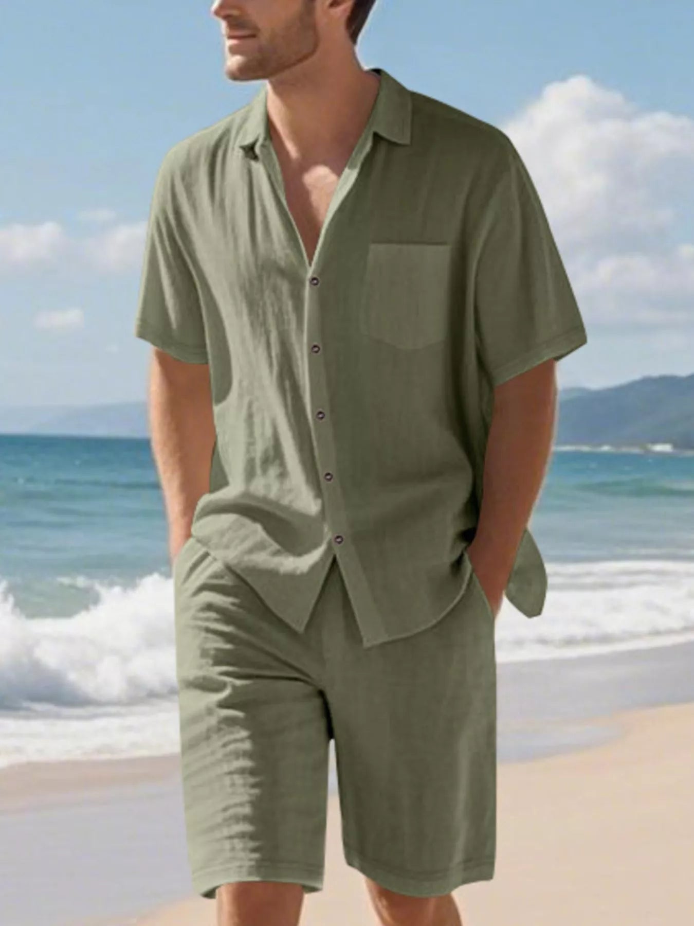 NEWYORKLISTED ATLAS MEN'S COLLECTION: Man wearing a green shirt and shorts on a beach with ocean and sky in the background