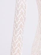 Close-up of a textured beige fabric on a light gray background