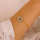 NEWYORKLISTED Valentine's Day Specials: Gold anklet with a heart-shaped charm on a person's ankle against a neutral background