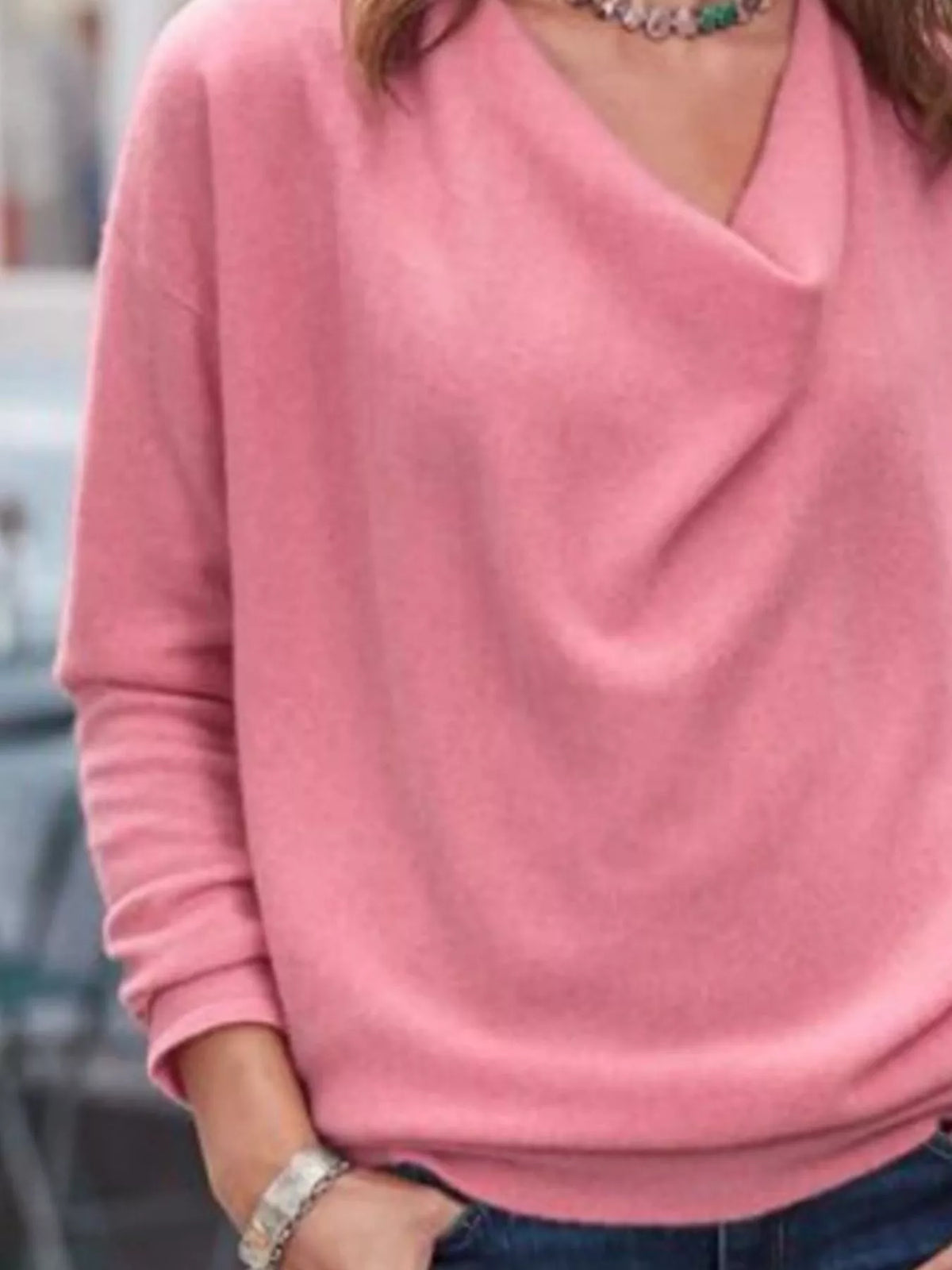 NEWYORKLISTED STYLE COLLECTION: Person wearing a pink sweater with a blurred background