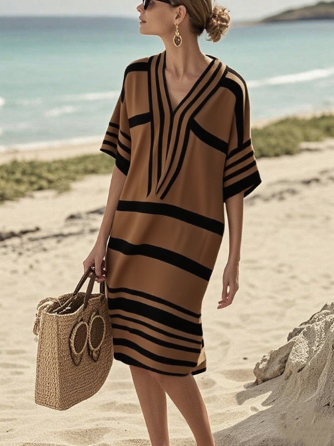 NEWYORKLISTED STYLE COLLECTION: Woman wearing a brown and black striped dress on a beach