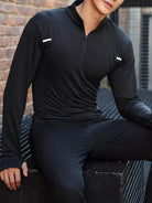 NEWYORKLISTED ATLAS MEN'S COLLECTION: Person wearing a black athletic outfit sitting on a metal bench with a cityscape background.
