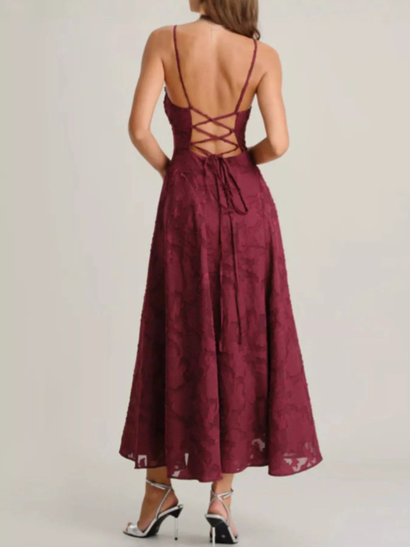 NEWYORKLISTED STYLE COLLECTION: Burgundy lace dress with criss-cross back on a plain background
