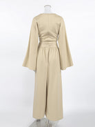 NEWYORKLISTED STYLE COLLECTION: Beige dress with long sleeves on a mannequin against a white background