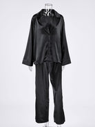 NEWYORKLISTED Intimate Apparel Collection: Black satin pajama set on a mannequin against a white background