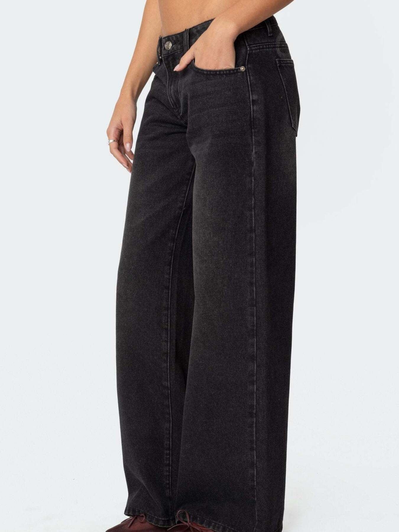 NEWYORKLISTED STYLE COLLECTION: Black wide-leg jeans worn by a person on a white background