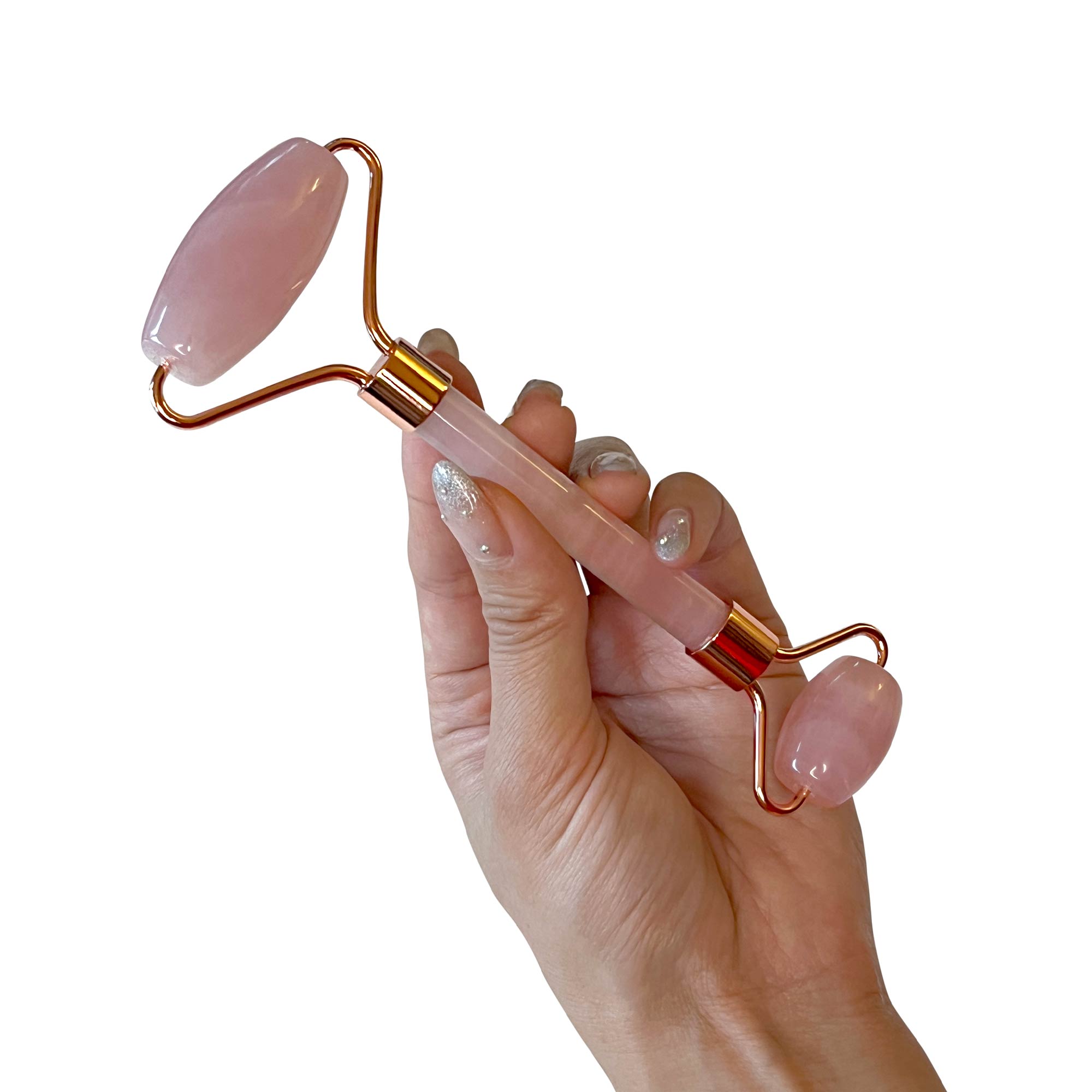 NEWYORKLISTED Cosmetic Collection: Hand holding a pink and gold facial roller against a white background