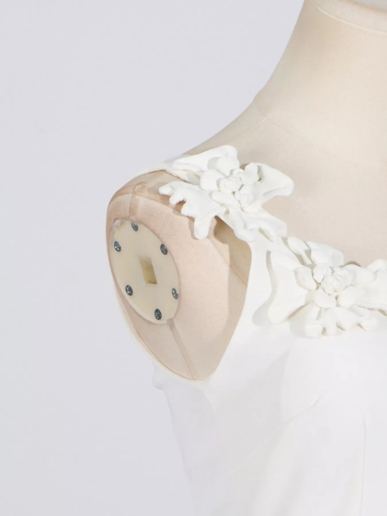 NEWYORKLISTED STYLE COLLECTION: White lace dress on a mannequin with a plain background