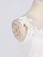 NEWYORKLISTED STYLE COLLECTION: White lace dress on a mannequin with a plain background