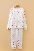 NEWYORKLISTED Intimate Apparel Collection: White pajama set with red heart patterns on a beige background