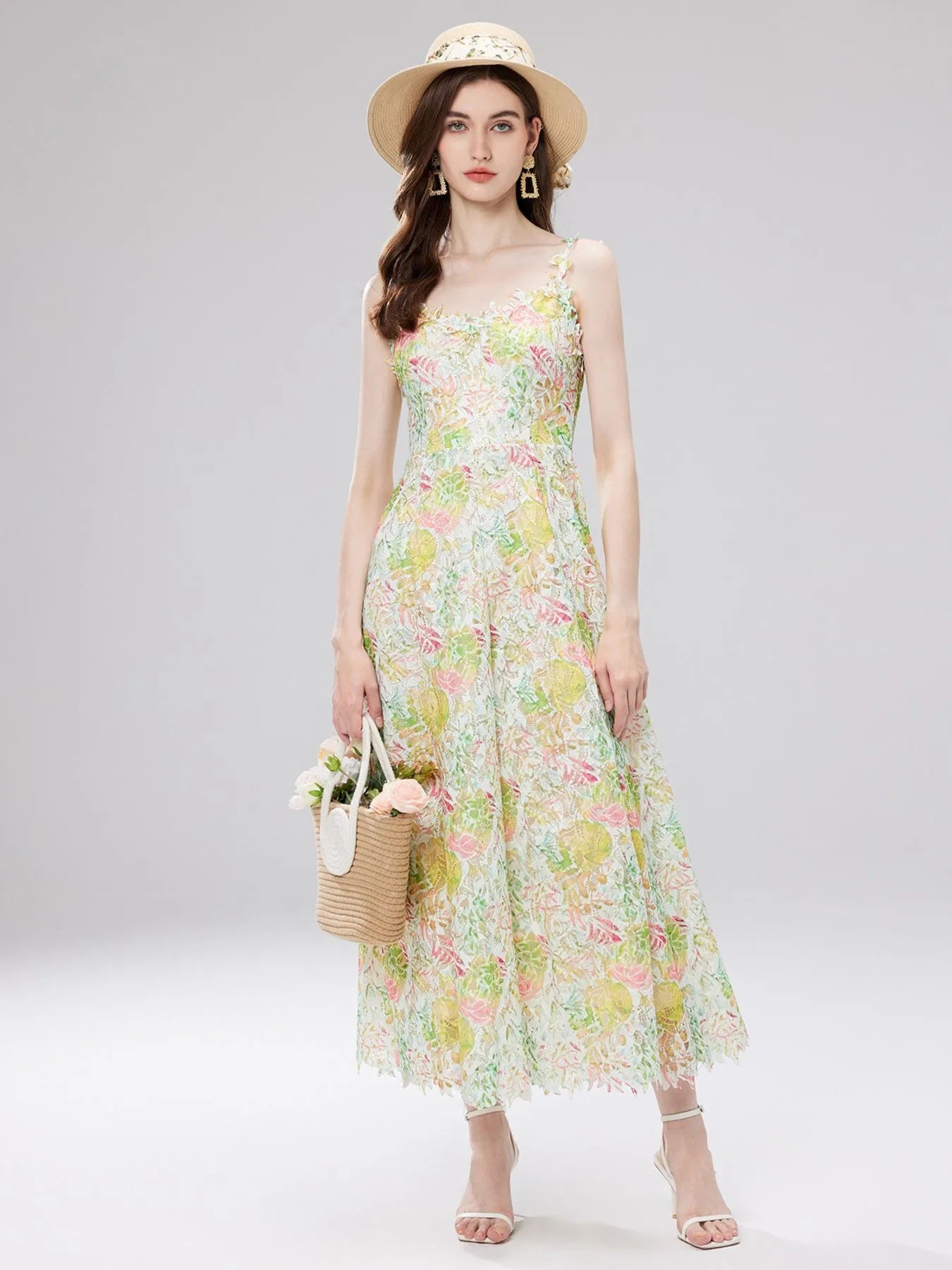 NEWYORKLISTED STYLE COLLECTION: Woman wearing a floral dress and straw hat on a gray background