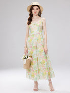 NEWYORKLISTED STYLE COLLECTION: Woman wearing a floral dress and straw hat on a gray background