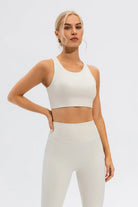 NEWYORKLISTED ACTIVEWEAR COLLECTION: Woman wearing a white athletic outfit on a light gray background