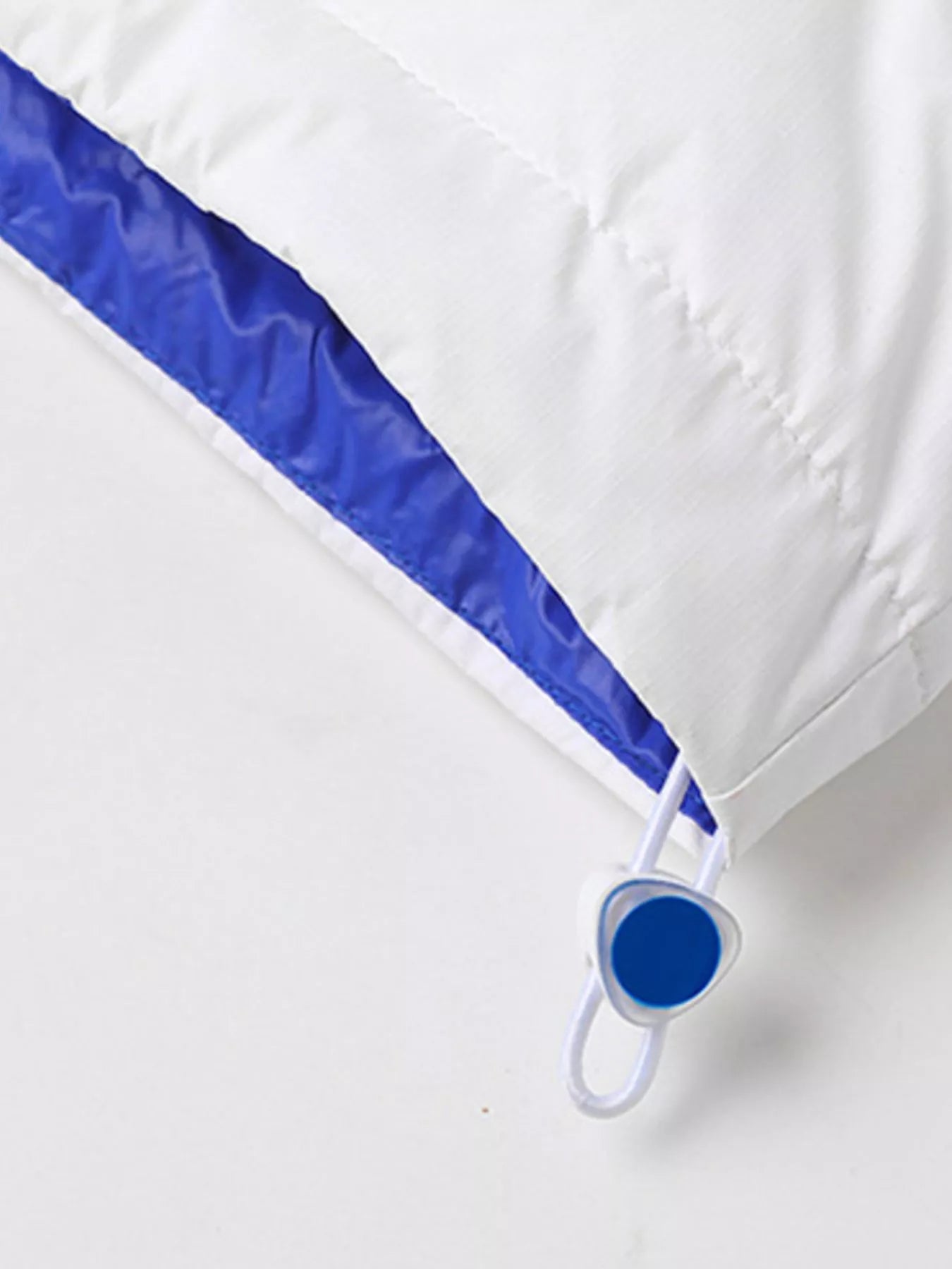 NEWYORKLISTED ATLAS MEN’S COLLECTION: White comforter with blue trim on a white background