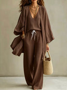 NEWYORKLISTED STYLE COLLECTION: Woman wearing a brown outfit with a beige background