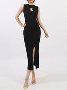 NEWYORKLISTED RUNWAY STYLE: Black sleeveless dress with a gold brooch on a white background