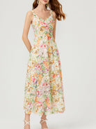NEWYORKLISTED STYLE COLLECTION: Woman wearing a floral dress on a white background