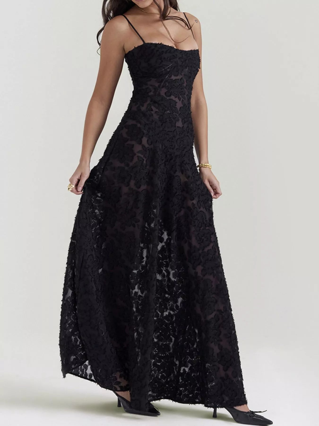 NEWYORKLISTED STYLE COLLECTION: Black lace dress worn by a model on a white background