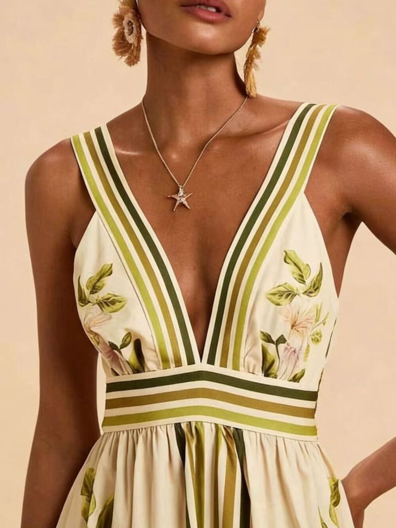 NEWYORKLISTED STYLE COLLECTION: Woman wearing a floral dress with green and yellow stripes on a beige background
