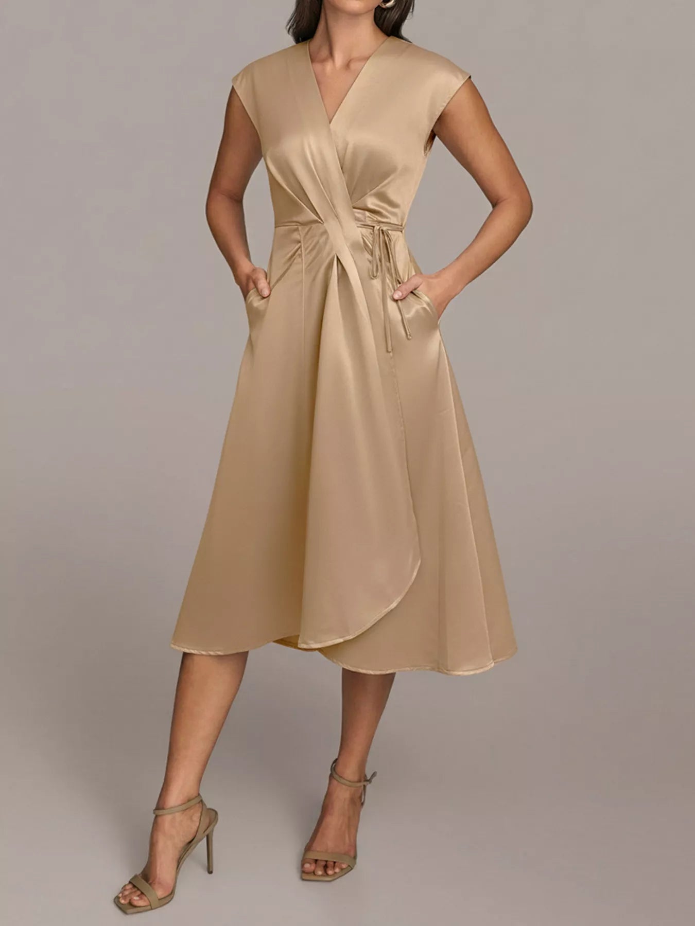 NEWYORKLISTED RUNWAY STYLE: Beige dress worn by a model on a plain background